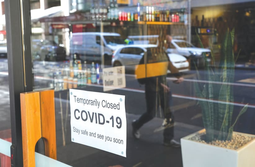  A SIGN IS POSTED in the window of a closed cafe in Sydney last week. (photo credit: REUTERS/LOREN ELLIOTT)