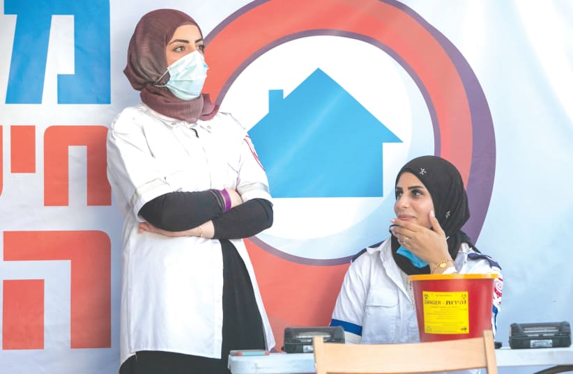  MEDICAL PERSONNEL at a temporary vaccination center in Kfar Qassem last month.  (photo credit: YOSSI ALONI/FLASH90)