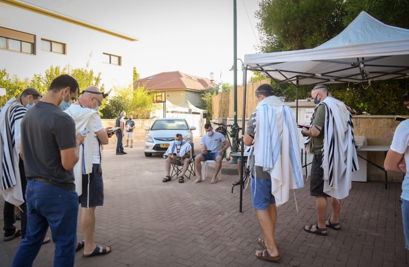  Orthodox Jews pray outside, as they keep a distance of 2 meters, as required by the restrictions to prevent the spread of the Covid-virus.  September 27, 2020.  (photo credit: FLASH90)