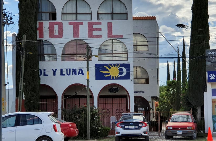 A police patrol car is parked outside the Sol y Luna hotel after gunmen stormed the hotel and kidnapped some 20 foreigners believed to be mostly from Haiti and Venezuela, according to state's attorney general office, in Matehuala, in San Luis Potosi state, Mexico September 14, 2021. (photo credit: REUTERS/STRINGER)