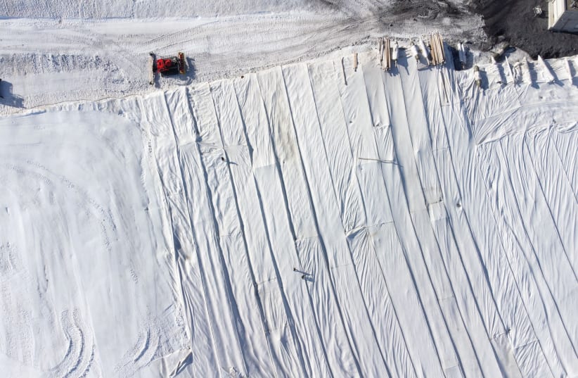  BLANKETS COVER parts of the glacier to protect it against melting on Mount Titlis near the Alpine resort of Engelberg, Switzerland, last month. (photo credit: ARND WIEGMANN / REUTERS)