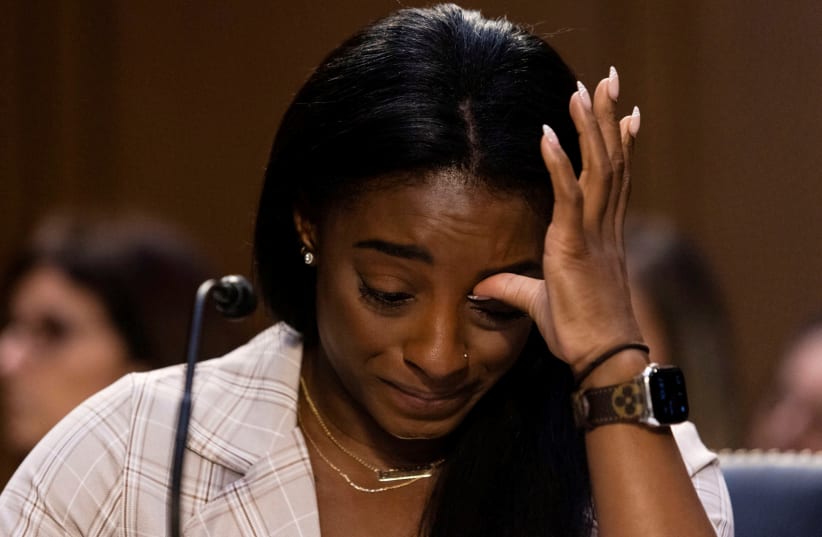 US Olympic gymnast Simone Biles testifies during a Senate Judiciary hearing about the Inspector General's report on the FBI handling of the Larry Nassar investigation of sexual abuse of Olympic gymnasts. (photo credit: GRAEME JENNINGS/POOL VIA REUTERS)