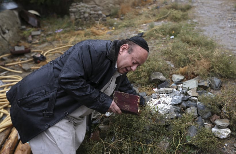  Zabulon Simantov, an Afghan Jew, prays at a Jewish cemetery in Kabul November 5, 2013. In his 50s, Simintov is the last known Afghan Jew to remain in the country. He has become something of a celebrity over the years and his rivalry with the next-to-last Jew, who died in 2005, inspired a play. (photo credit: REUTERS/OMAR SOBHANI)