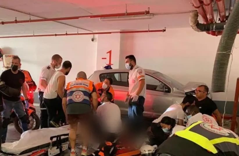 MDA paramedics administer treatment after a car crashed into a wall in an underground parking lot in Holon on September 19, 2021. (photo credit: MDA OPERATIONAL COVERAGE)