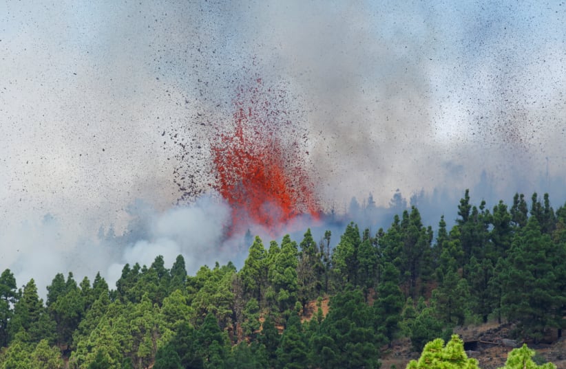  Lava and smoke are seen following the eruption of a volcano in the Cumbre Vieja national park at El Paso, on the Canary Island of La Palma (photo credit: Borja Suarez/Reuters)