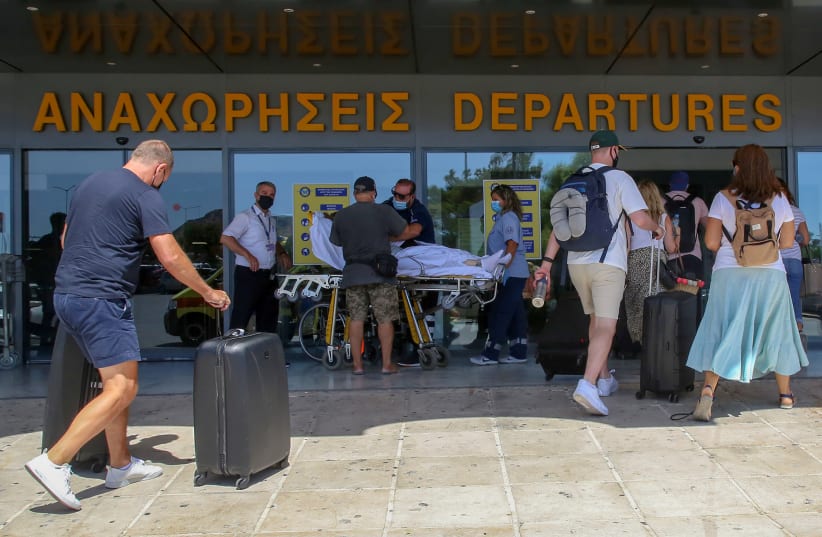  Tourists enter the departures lounge of the airport of Heraklion, on the island of Crete, Greece, September 8, 2020.Tourists enter the departures lounge of the airport of Heraklion, on the island of Crete, Greece, September 8, 2020. (photo credit: REUTERS/STEFANOS RAPANIS)