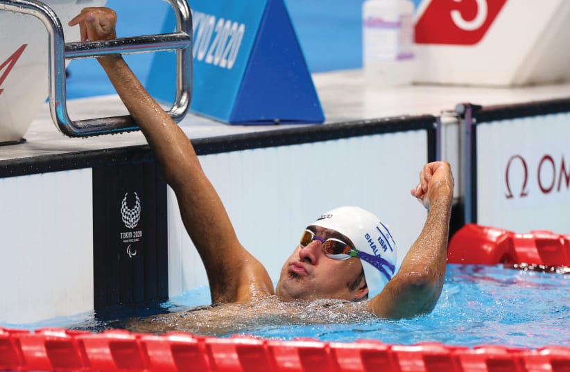  PARALYMPIAN IYAD SHALABI celebrates after bringing home the swimming gold for Israel in the 100-meter backstroke, September 2. (photo credit: MARKO DJURICA/REUTERS)