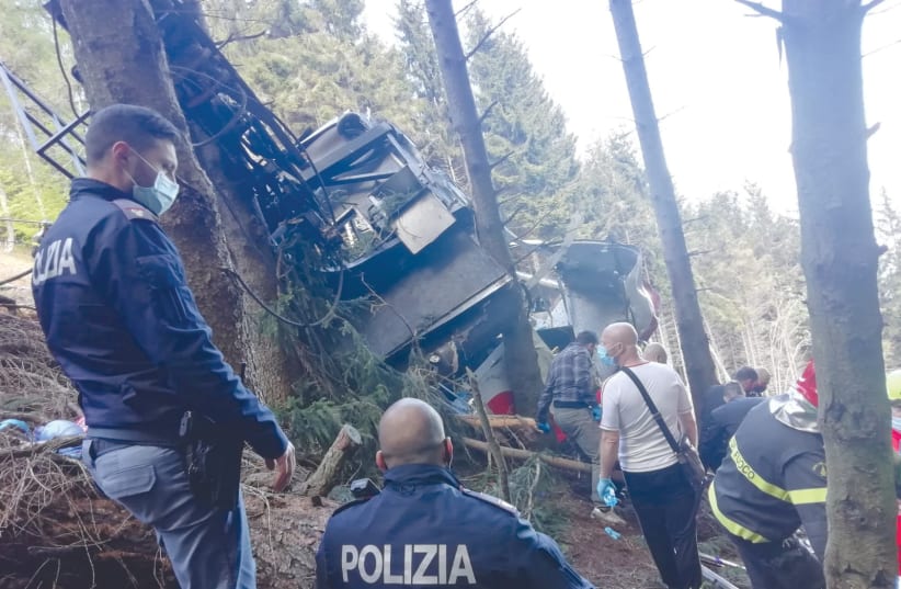  ITALIAN POLICE AND rescue service members are seen near the crashed cable car after it collapsed in Stresa, near Lake Maggiore, in May. (photo credit: REUTERS)