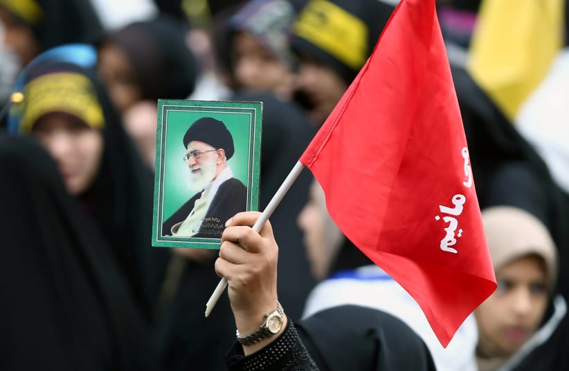  An Iranian protester holds the picture of Iranian Supreme Leader Ayatollah Ali Khamenei as she attends an anti US demonstration, marking the 40th anniversary of the US embassy takeover, near the old US embassy in Tehran, Iran, November 4, 2019.  (photo credit: NAZANIN TABATABAEE/WANA (WEST ASIA NEWS AGENCY) VIA REUTERS)