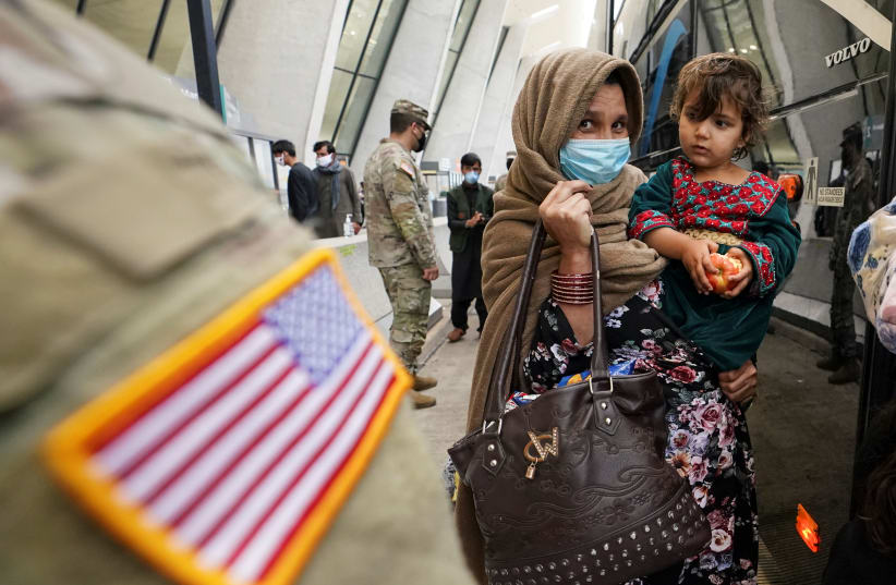  A day after U.S. forces completed its troop withdrawal from Afghanistan, refugees board a bus taking them to a processing center upon their arrival at Dulles International Airport in Dulles, Virginia, US, September 1, 2021.  (photo credit: REUTERS/KEVIN LAMARQUE)