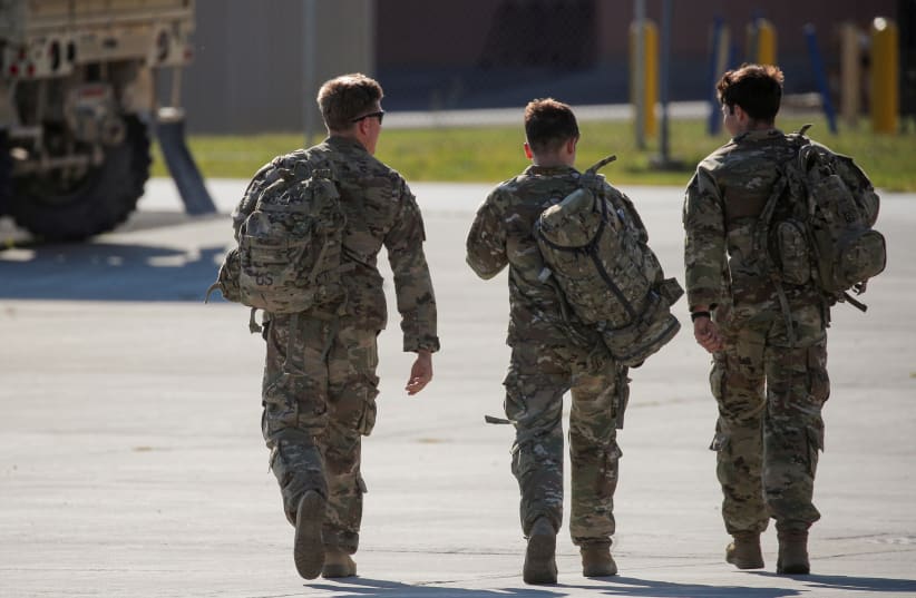  Soldiers from the 4th Battalion, 31st Infantry Regiment, 2nd Brigade Combat Team of the 10th Mountain Division, walk together after returning home from deployment in Afghanistan, at Fort Drum, New York, US, September 6, 2021. (photo credit: REUTERS/BRENDAN MCDERMID/FILE PHOTO)