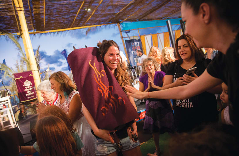  WOMEN DANCE with a Torah on Simhat Torah at the the Tel Aviv Port in 2019.  (photo credit: MIRIAM ALSTER/FLASH90)