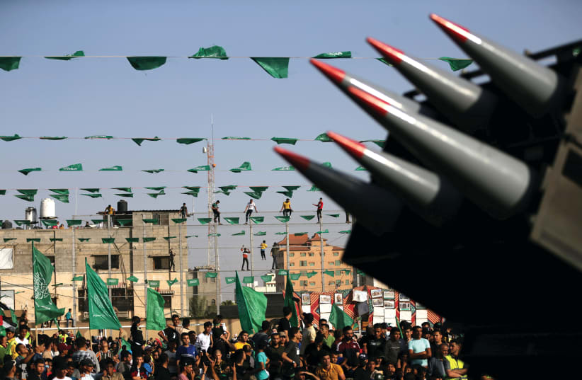  HAMAS SUPPORTERS attend an anti-Israel rally as rockets are displayed on a truck in Rafah, in the southern Gaza Strip in May. (photo credit: IBRAHEEM ABU MUSTAFA/REUTERS)