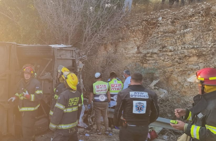 Fire and Rescue, Magen David Adom and United Hatzalah paramedics are trying to evacuate the victims of a deadly crash in the Galilee when a bus collided with a van and car, killing at least five and injuring dozens. (photo credit: FIRE AND RESCUE SERVICE)