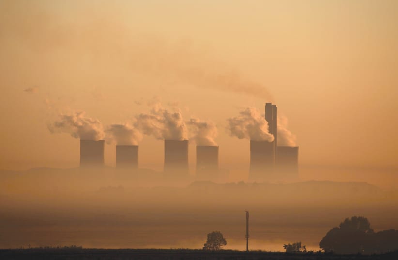  STEAM RISES at sunrise from the coal-fired Lethabo Power Station, owned by state power utility ESKOM near Sasolburg, South Africa. (photo credit: SIPHIWE SIBEKO/REUTERS)