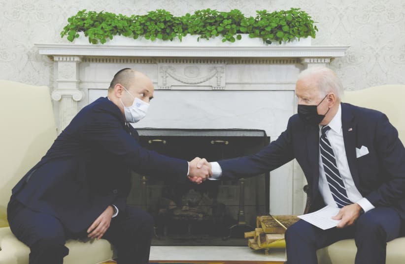  US PRESIDENT Joe Biden and Prime Minister Naftali Bennett shake hands during a meeting at the White House in August. (photo credit: JONATHAN ERNST / REUTERS)