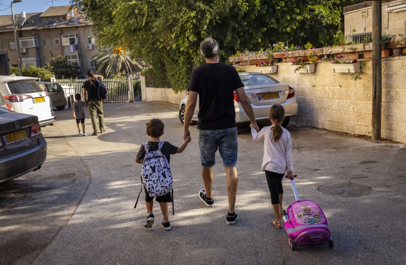  Young Israeli students with their parents make their way to school and kindergarten in Jerusalem on September 30, 2021. (photo credit: OLIVIER FITOUSSI/FLASH90)