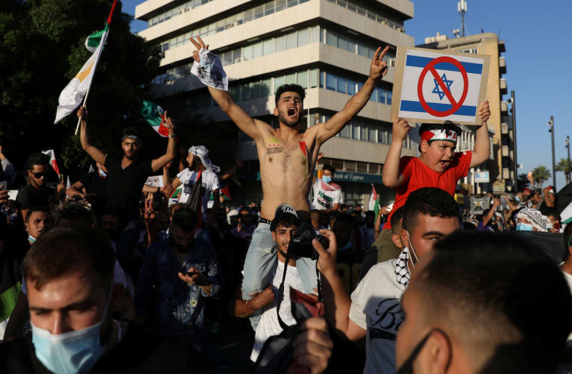 Pro-Palestinian protestors shouts logans during a demonstration in Eleftheria square, following a flare-up of Israeli-Palestinian violence, in Nicosia, Cyprus May 16, 2021. (photo credit: REUTERS/YIANNIS KOURTOGLOU)
