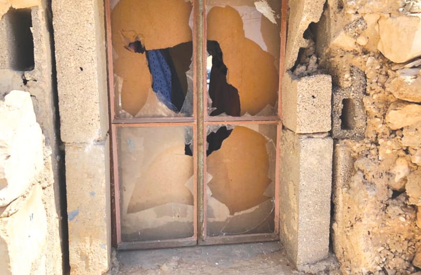  ONE OF the shattered windows in Hamamdeh family’s stone home in Khirbet al-Mufaqarah. (photo credit: TOVAH LAZAROFF)