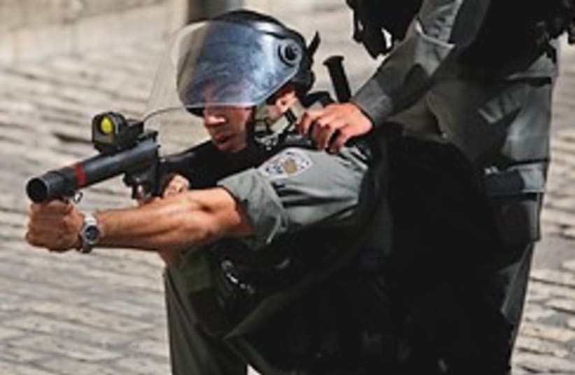 Border policeman fires tear gas 248.88 (photo credit: )