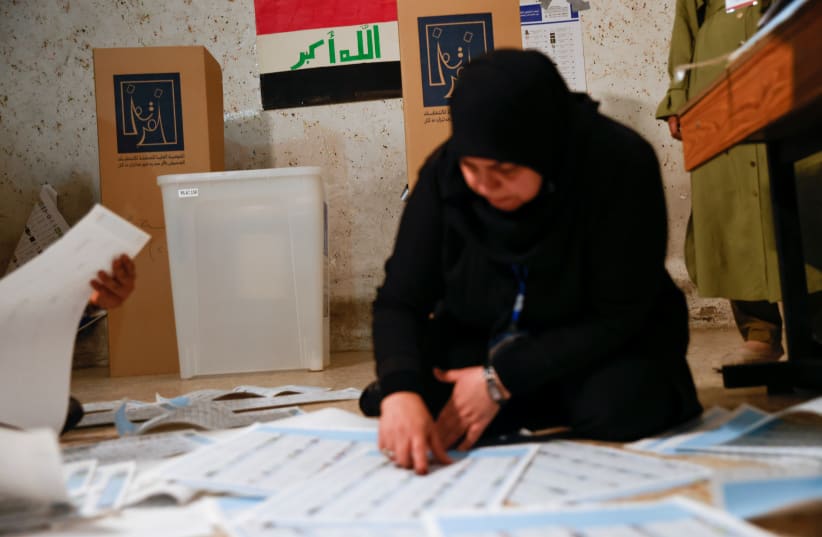  An official works at a polling station during the parliamentary election, in Baghdad, Iraq, October 10, 2021 (photo credit: REUTERS/THAIER AL-SUDANI)