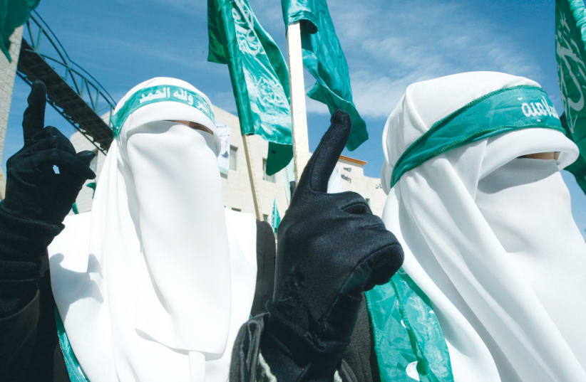  Hamas supporters wearing veils and gloves take part in an anti-Israel rally in Jenin.  (photo credit: MOHAMAD TOROKMAN/REUTERS)