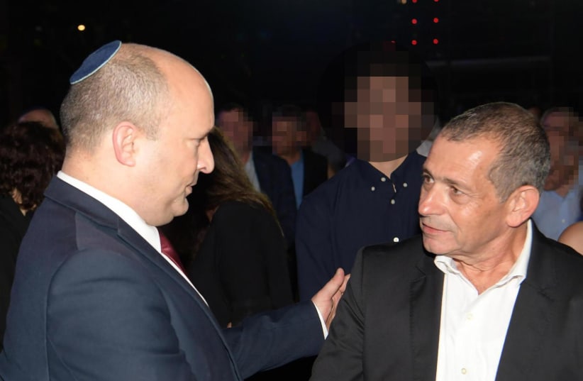  PM Naftali Bennet shakes hands with outgoing leader of the Shin Bet, Nadav Argaman. (photo credit: AMOS BEN-GERSHOM/GPO)