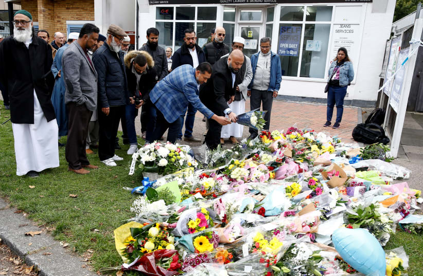  Members of the local Muslim community lay flowers in tribute to British MP David Amess, who was stabbed to death during a meeting with constituents, near the Belfairs Methodist Church, in Leigh-on-Sea, Britain, October 16, 2021.  (photo credit: REUTERS/PETER NICHOLLS)