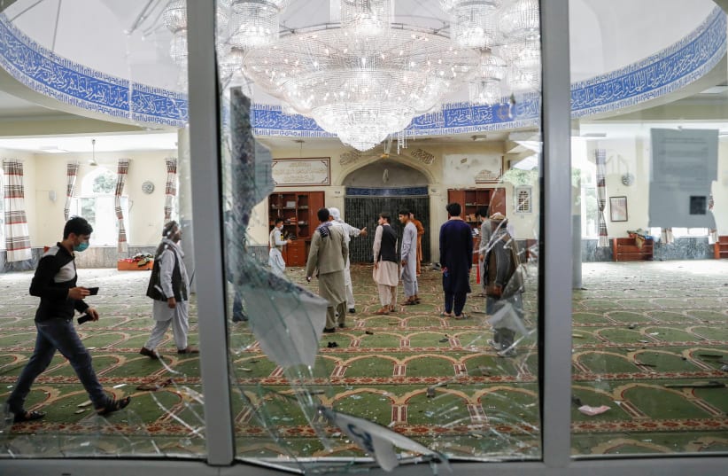  Men inspect the site of a blast inside a mosque in Kabul, Afghanistan June 12, 2020. (photo credit: REUTERS/MOHAMMAD ISMAIL)
