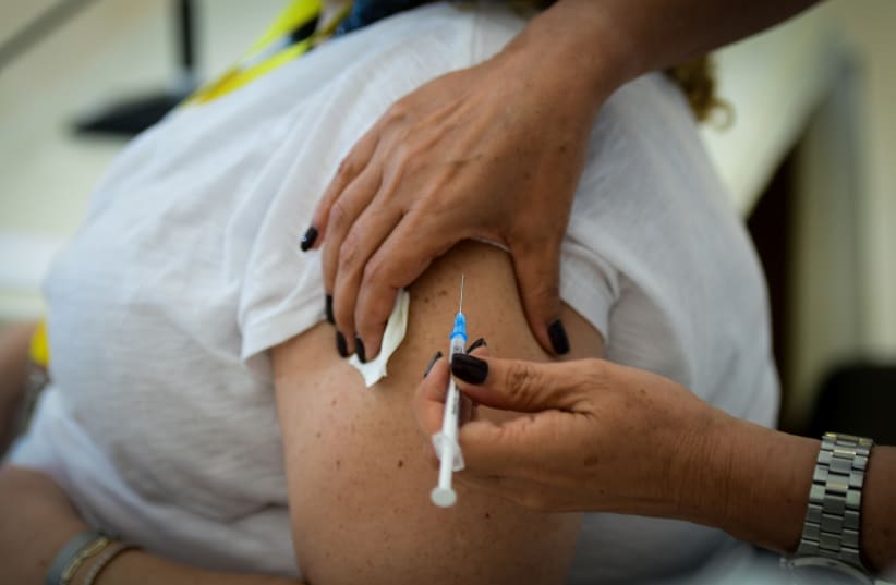 Medical staff receive their third COVID-19 vaccine shot at Meir Medical Center in Kefar Sava, August 13, 2021. (photo credit: AVSHALOM SASSONI/FLASH90)