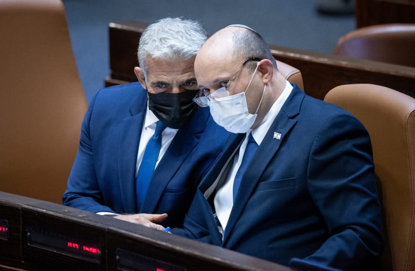  Israeli prime minister Naftali Bennett and Minister of Foreign Affairs Yair Lapid at the Israeli parliament during a plenum session in the assembly hall of the Israeli parliament, in Jerusalem, on August 2 2021. (photo credit: YONATAN SINDEL/FLASH 90)