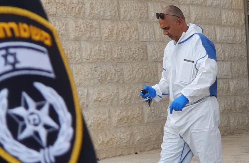  An Israel Police forensic investigator is seen at the scene of the crime in Beit Shemesh on October 30, 2021 (photo credit: ISRAEL POLICE)