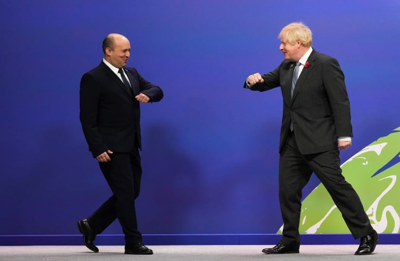  British Prime Minister Boris Johnson greets Israel's Prime Minister Naftali Bennett as he arrives for the UN Climate Change Conference (COP26) in Glasgow, Scotland, Britain November 1, 2021. (photo credit: CHRISTOPHER FURLONG/POOL VIA REUTERS)