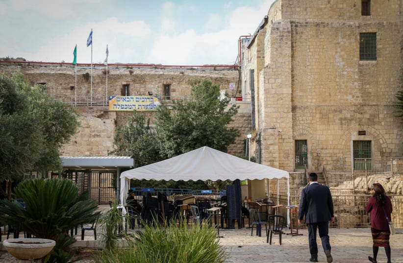  Jews seen outside the Cave of the Patriarchs in the West Bank city of Hebron, on October 21, 2021. (photo credit: GERSHON ELINSON/FLASH90)