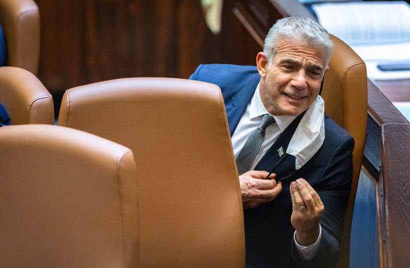  Israeli minister of Foreign Affairs Yair Lapid speeks during a plenum session and a vote on the state budget at the assembly hall of the Israeli parliament, in Jerusalem on November 3, 2021. (photo credit: OLIVIER FITOUSSI/FLASH90)