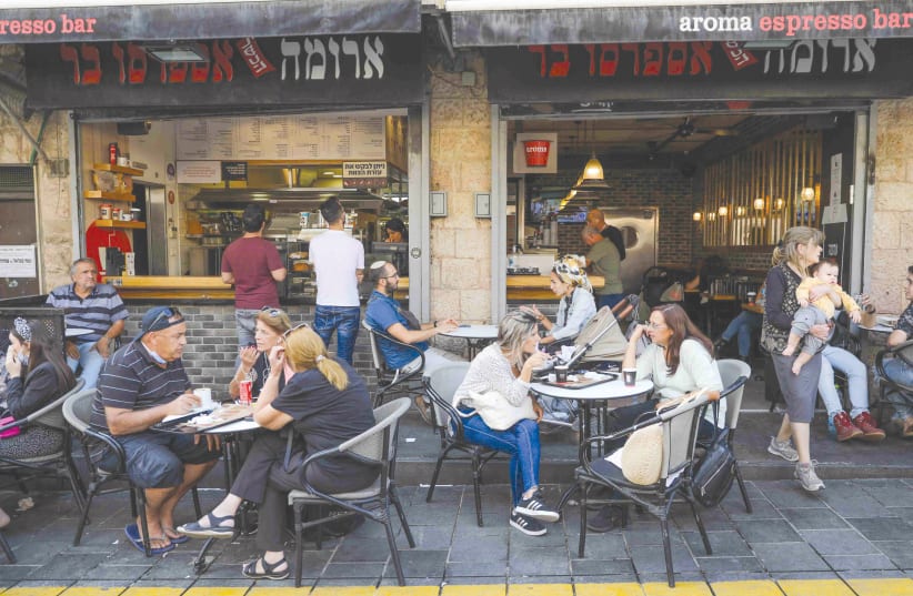 PATRONS OF A Jerusalem cafe. The pandemic gave people a chance to take stock of and reimagine their lives, said Dr. Talya Miron-Shatz, founding director of the Center for Medical Decision Making at Ono Academic College. (photo credit: MARC ISRAEL SELLEM/THE JERUSALEM POST)