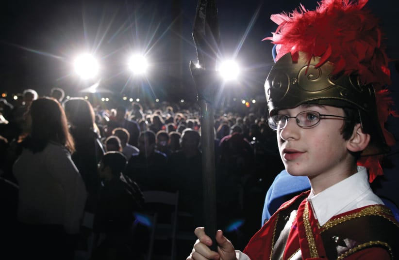  TEENAGER ZALMAN RAICHIK dresses as a Maccabee at the national menorah-lighting ceremony in Washington. The  book portrays the life of a teenager at the time when Hanukkah took place. (photo credit: YURI GRIPAS/REUTERS)