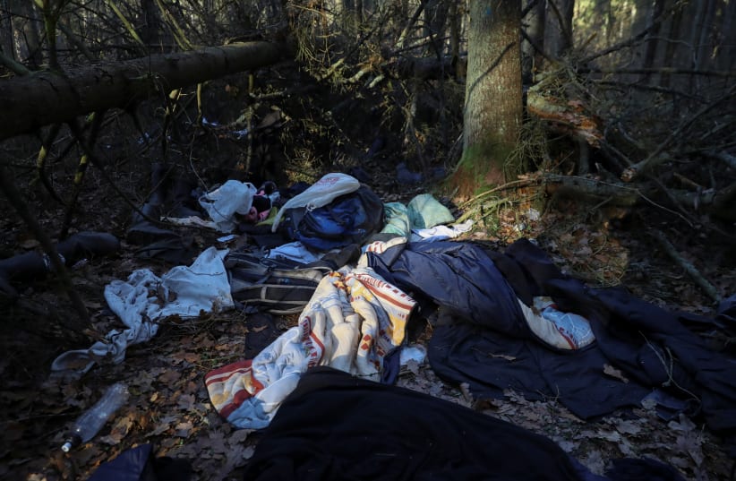  Belongings of migrants are pictured in the forest after they left temporary night camp during migrant crisis on Belarusian - Polish border near Hajnowka, Poland, November 10, 2021.  (photo credit: REUTERS/KACPER PEMPEL)