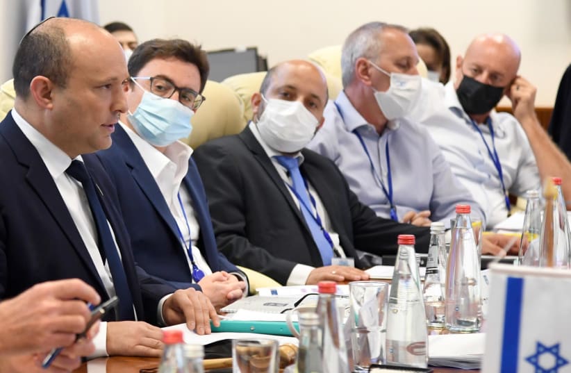 Israel's Prime Minister Naftali Bennett and other top officials are seen following the completion of the COVID-19 'war games' exercise. (photo credit: HAIM ZACH/GPO)