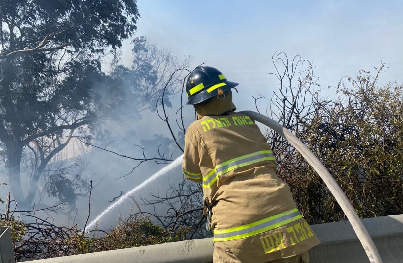  Israel Fire and Rescue Services firefighter attempting to extinguish a fire on November 13, 2021 (photo credit: ISRAEL FIRE AND RESUCE SERVICES)