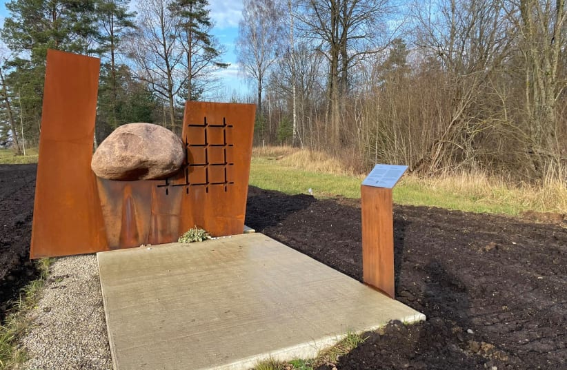  A bicycle path passes on either side of a monument to Holocaust survivors buried in a mass grave in Šiauliai, Lithuania, pictured on Nov. 10, 2021. (photo credit: Courtesy of Rabbi Kalev Kerlin/JTA)