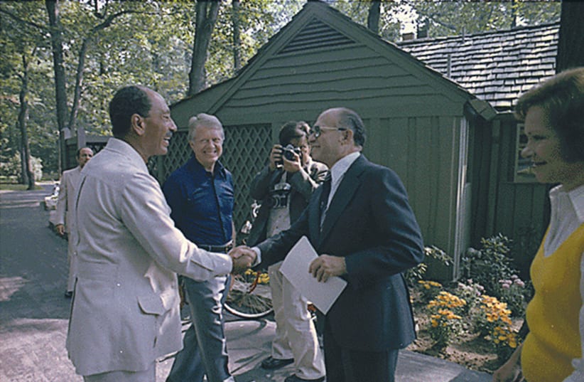  THEN-PRIME MINISTER Menachem Begin and Egyptian president Anwar Sadat greet each other at their first meeting at the Camp David summit as US president Jimmy Carter looks on in September 1978.  (photo credit: JIMMY CARTER LIBRARY/NATIONAL ARCHIVES/REUTERS)