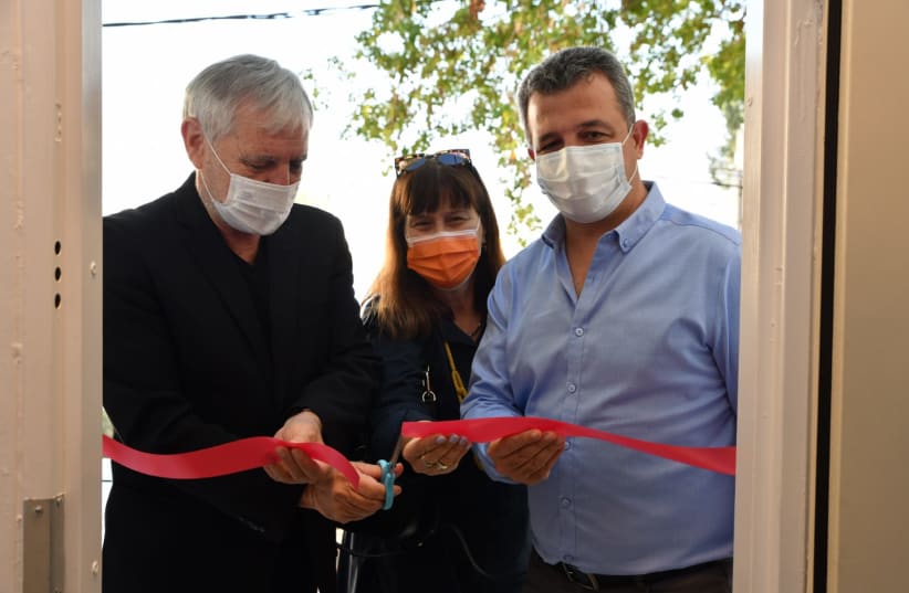 Welfare Minister Meir Cohen, Deputy Director-General of Social Services Iris Florentine and Ramat Gan's Mayor Carmel Shama Hacohen cut the ribbon, opening the first apartment in Israel designated for perpetrators of domestic violence who are getting treatment. (photo credit: YUVAL YOSEF/GPO)
