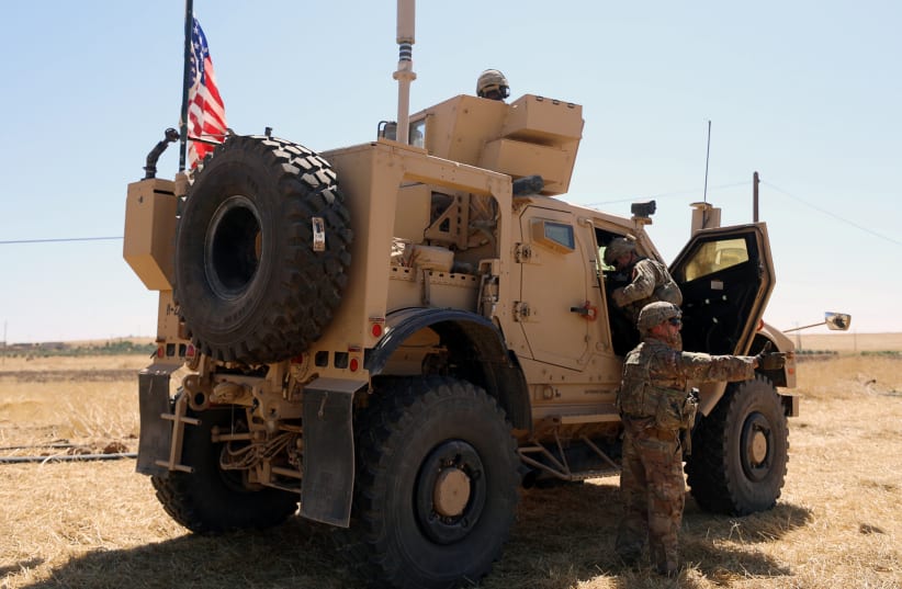  An American flag flutters on a U.S military vehicle during a joint U.S.-Turkey patrol, near Tel Abyad, Syria September 8, 2019 (photo credit: RODI SAID / REUTERS)