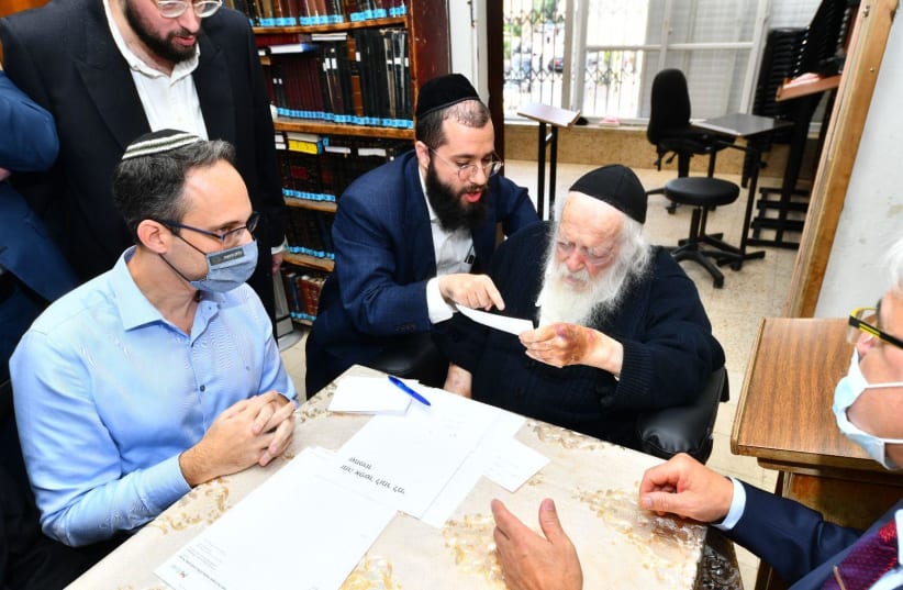  Rabbi Chaim Kanivesky meets with senior medical officials in his Bnei Brak home on Thursday (photo credit: SHUKI LERRER)
