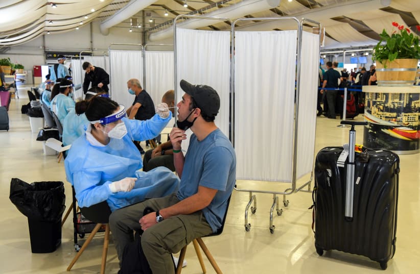  Medical technicians test passengers for COVID-19 at the Ben Gurion International Airport near Tel Aviv on March 8, 2021.  (photo credit: FLASH90)