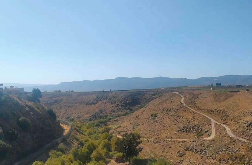  NORTH GHAJAR, in Lebanese territory, on the left, surrounded by a border fence, and the Lebanese village Wazzani to the right, with a Lebanese military road between them. (photo credit: Leor Bareli)