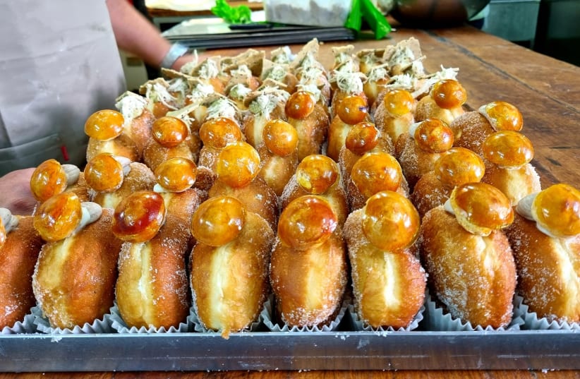  Two of the popular donuts created especially for Hanukkah this year. In the foreground are 'The Bride of Istanbul' and in the background are 'Old City' donuts. (photo credit: MAYA MARGIT/THE MEDIA LINE)