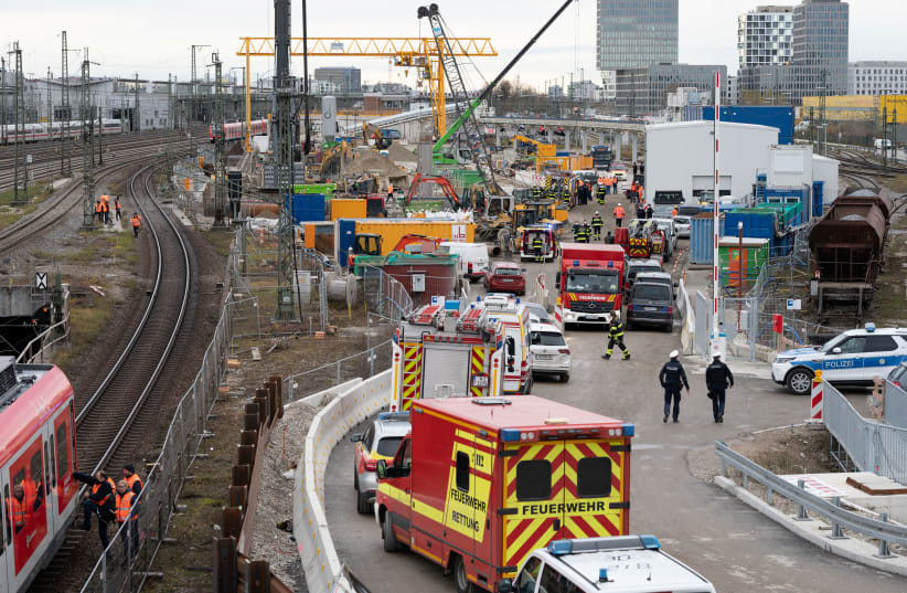Police and firefighters secure the scene after an old aircraft bomb exploded during construction work at a bridge the busy main train station, injuring three people in Munich, Germany, December 1, 2021. (photo credit: REUTERS/ANDREAS GEBERT)