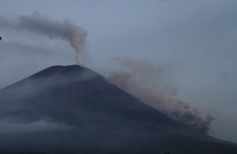 Mount Semeru spews hot clouds as seen from Pronojiwo, Lumajang, East Java province, Indonesia December 5, 2021. (photo credit: Antara Foto/Ari Bowo Sucipto/via REUTERS)